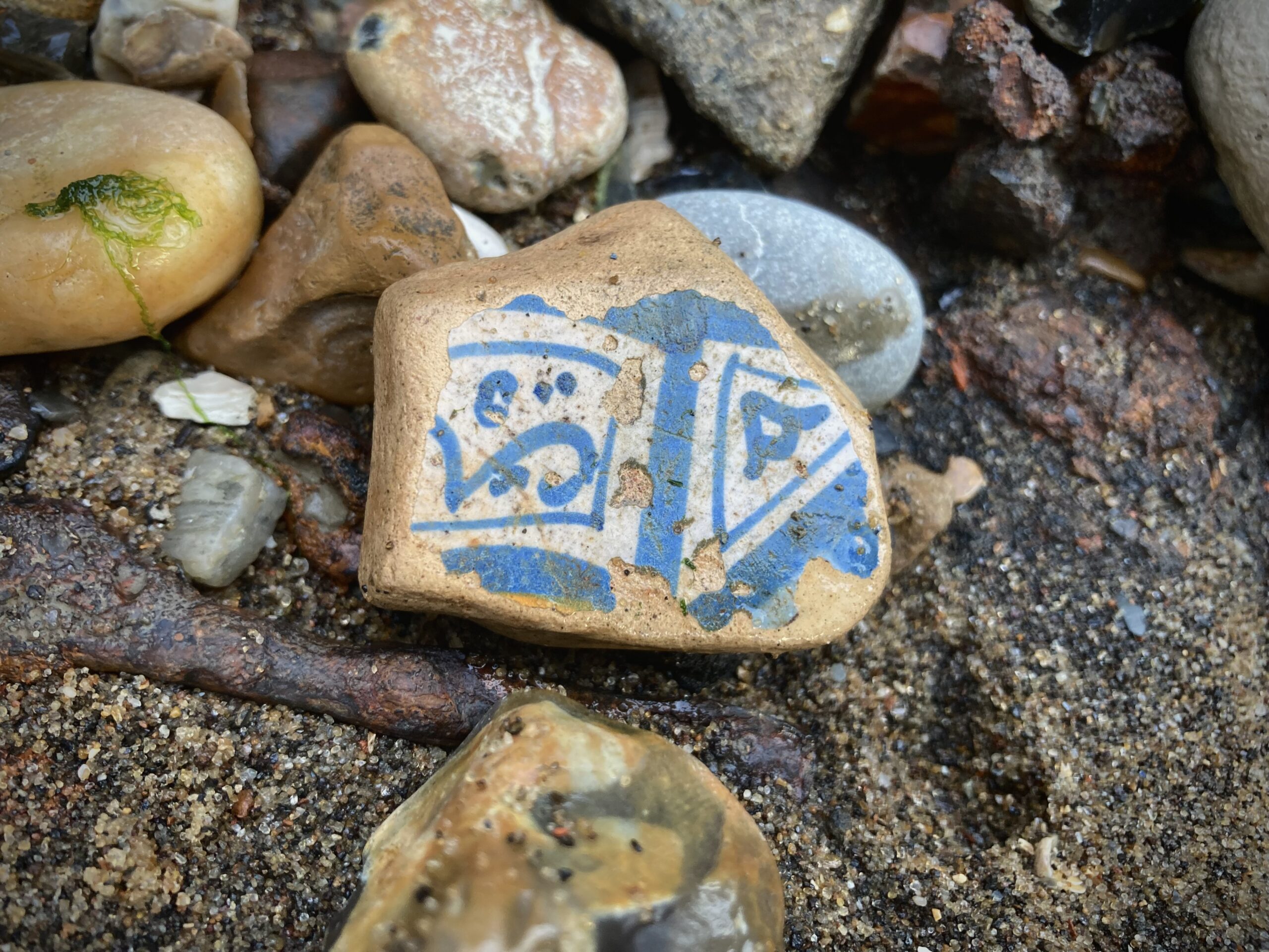 Sherd of tin-glazed Delftware tile with abstract symbols